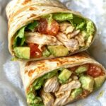 Chicken Avocado Wrap, featuring a freshly cut half wrap with layers of shredded chicken