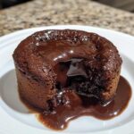 Chocolate Lava Cake, featuring a warm, gooey molten center oozing out from a perfectly baked dark chocolate cake